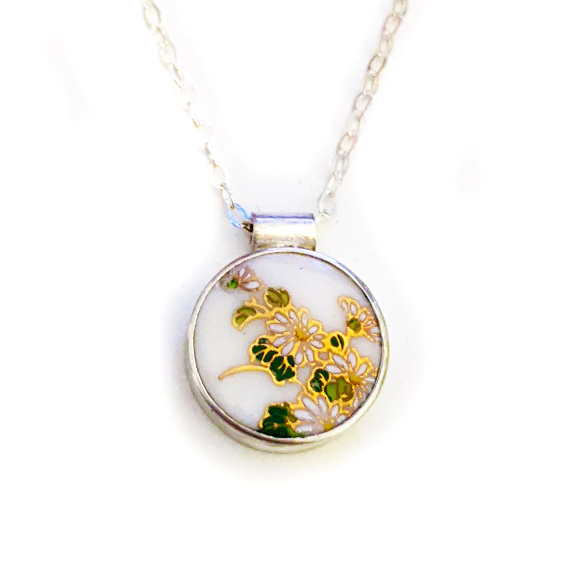 Ceramic artist and china painter Melanie Sherman creates beautiful sterling silver jewelry pieces with porcelain stones. Decorated with vintage decals from Europe and Japan, these one-of-kind pieces tell the story of historic porcelain wares, used as dinnerware in 18th century Europe.